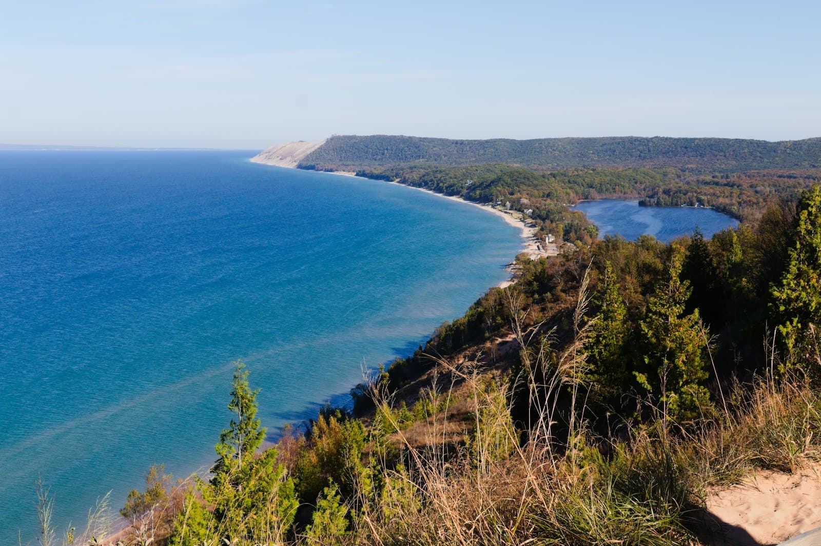 The wooded bluffs and shoreline of Lake Michigan from above