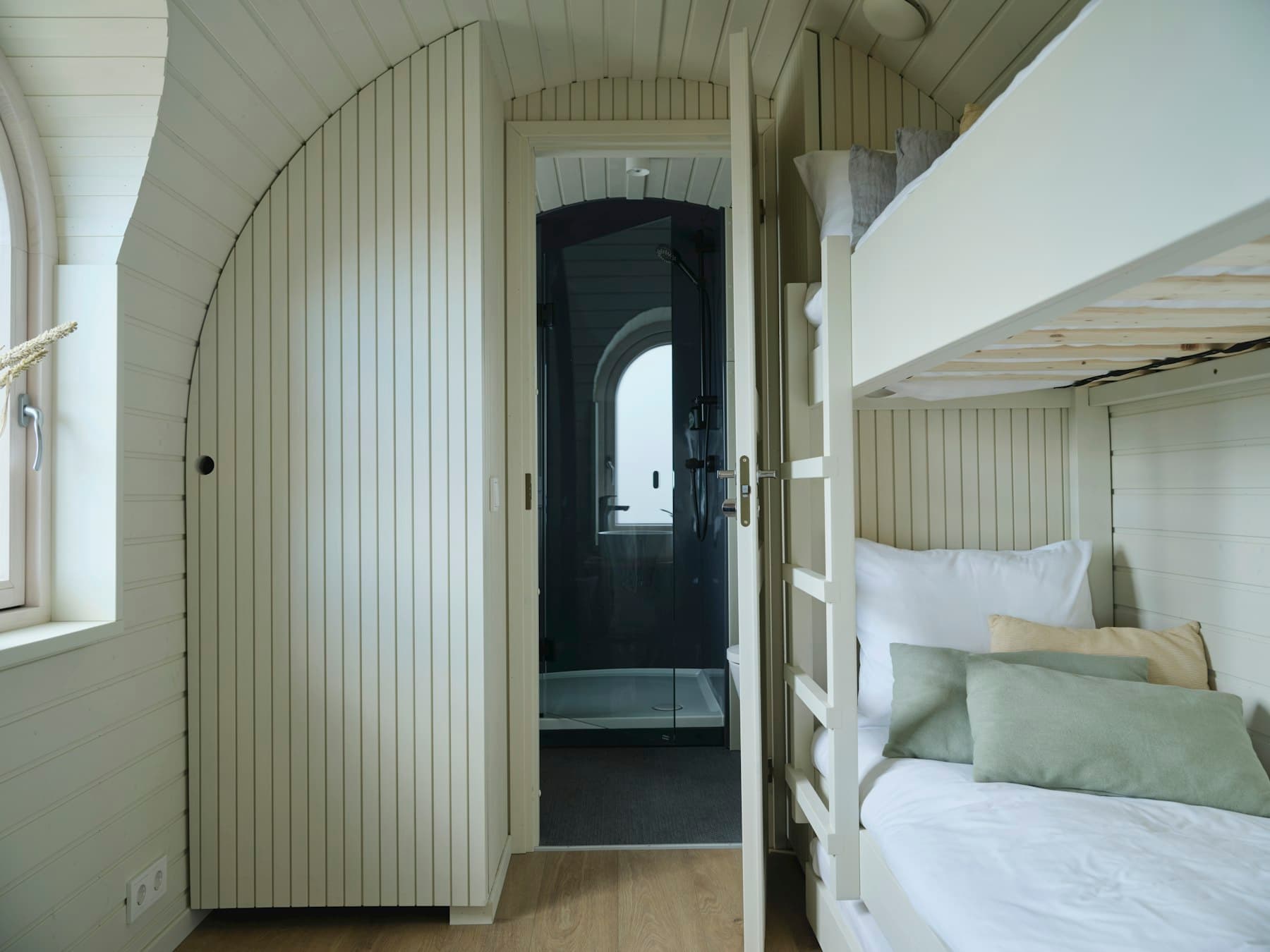 Built-in bunk room sleeping four, with its own bath through the arch