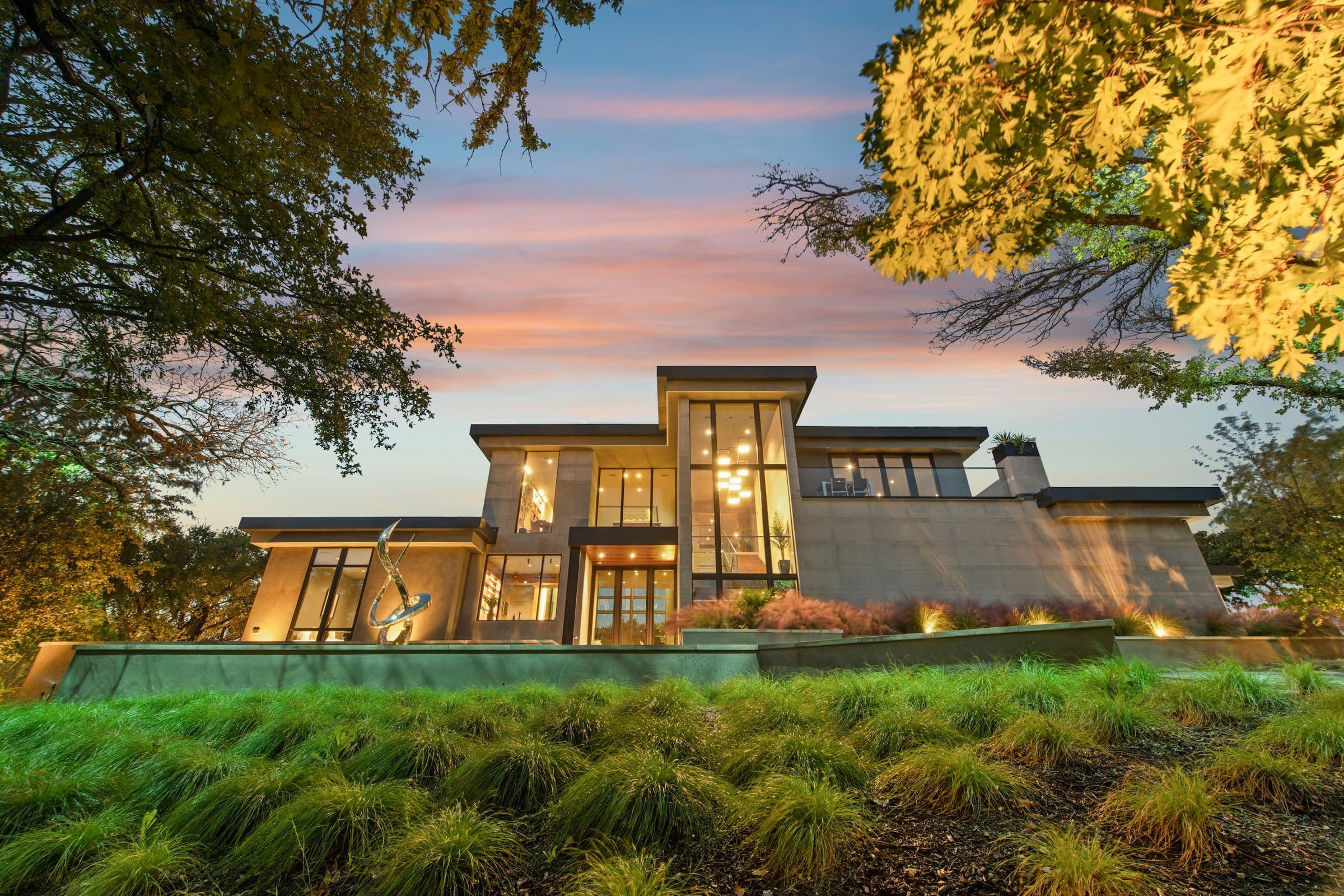 Grand Heights at dusk with warm light in every window
