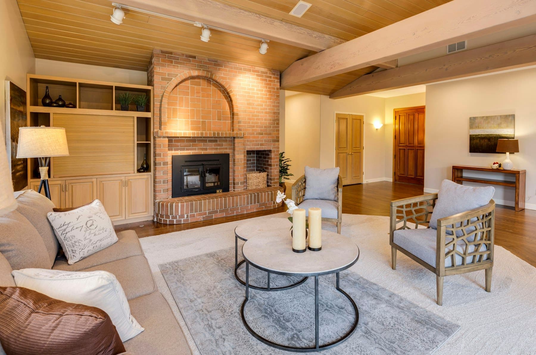 Lower-level lounge with an arched fireplace nook