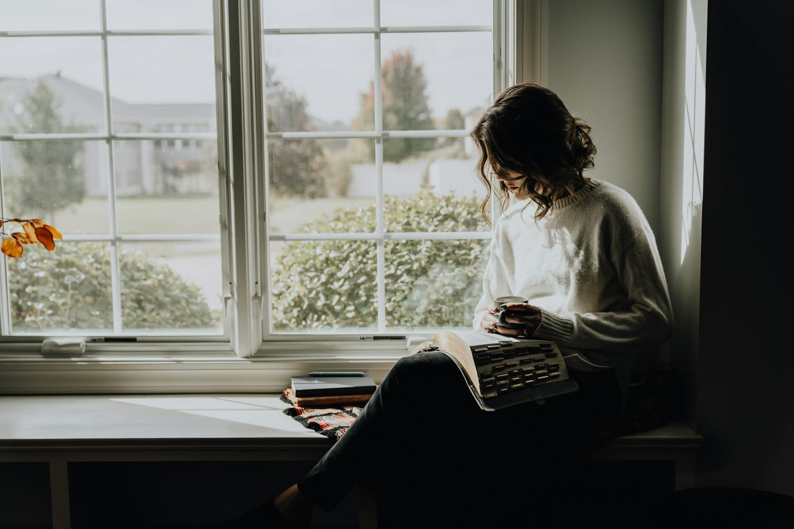 Reading by the window on a snowy morning