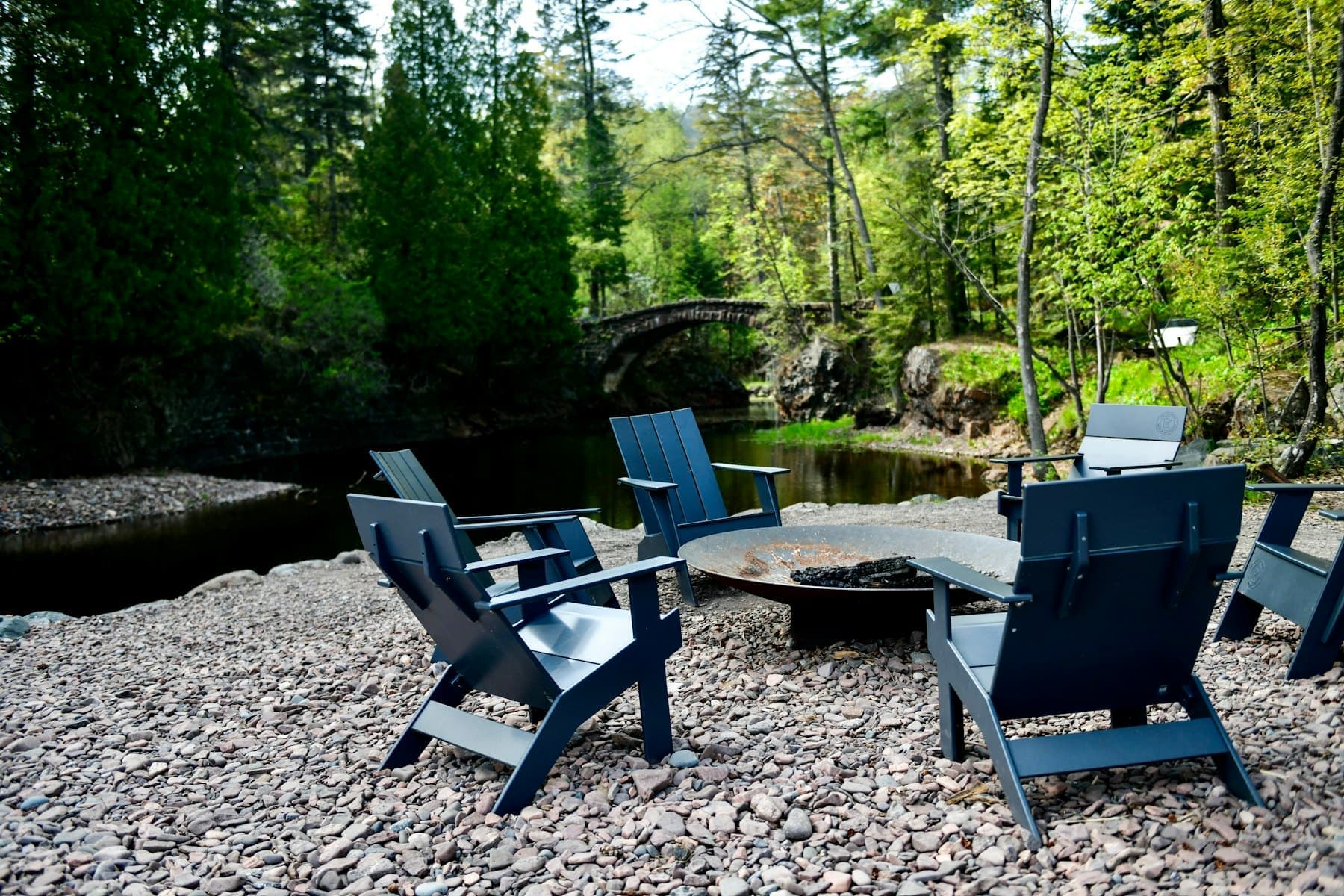 Adirondack chairs circled around the firepit